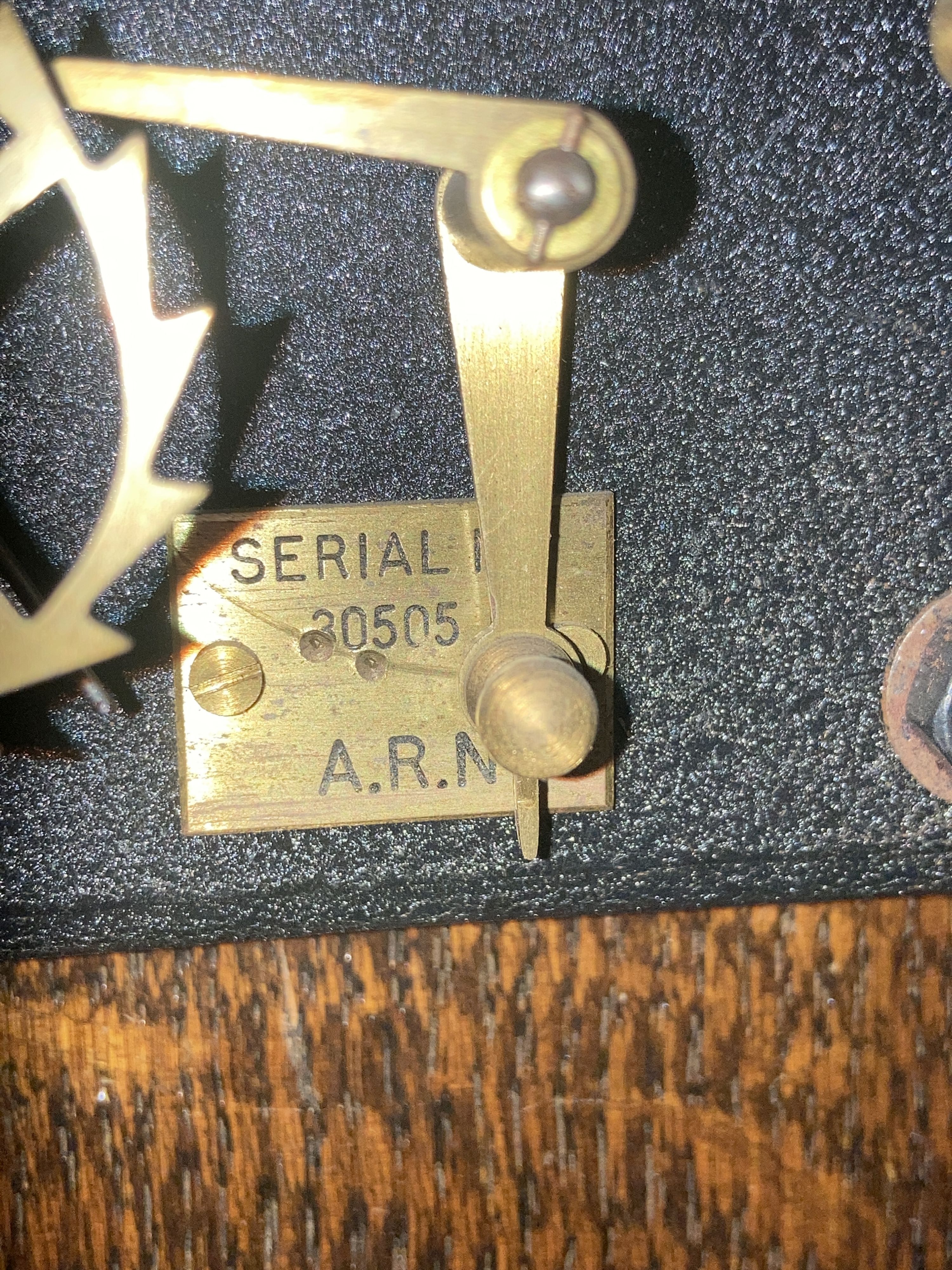 A Smiths English clock systems electric master clock in an arched oak case, with associated pendulum bob, marked ARN Serial No. 30505,